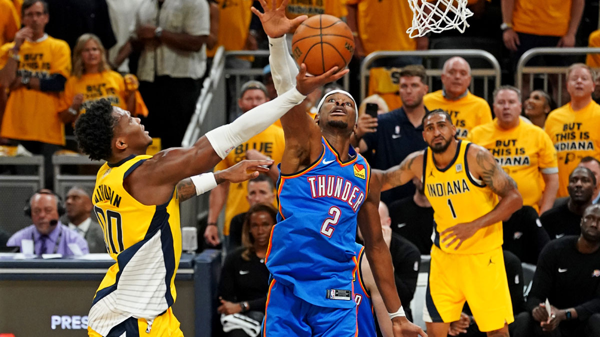 Thunder guard Shai Gilgeous-Alexander (2) in game three of the 2025 NBA Finals at Gainbridge Fieldhouse with the Pacers logo in the background