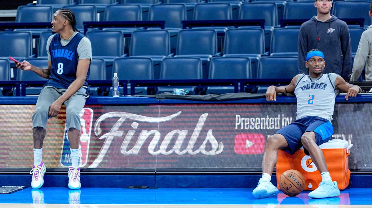 Thunder forward Jalen Williams (8) and Oklahoma City Thunder guard Shai Gilgeous-Alexander with the Pacers logo in the background and Thunder head coach Mark Daigneault in the background