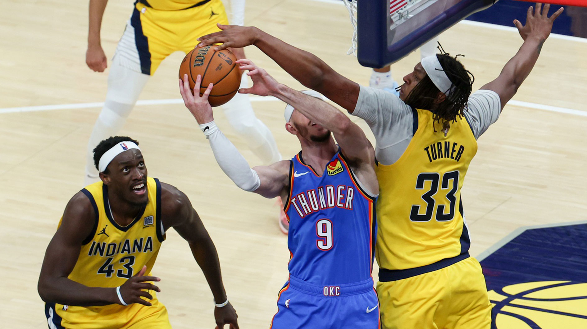 Indiana Pacers center Myles Turner (33) blocks a shot by Oklahoma City Thunder guard Alex Caruso (9) in the third quarter during game six of the 2025 NBA Finals at Gainbridge Fieldhouse