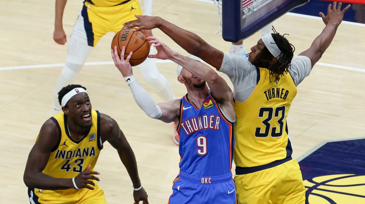Indiana Pacers center Myles Turner (33) blocks a shot by Oklahoma City Thunder guard Alex Caruso (9) in the third quarter during game six of the 2025 NBA Finals at Gainbridge Fieldhouse