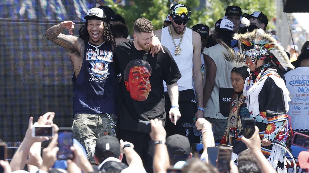 Thunder forward Jaylin Williams and Oklahoma City Thunder center Isaiah Hartenstein learn a dance from a Native American dancer during the Oklahoma City Thunder Champions parade