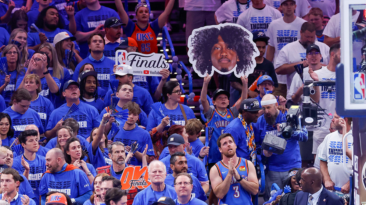 A fan holds up a cutout of Oklahoma City Thunder forward Jalen Williams (8) during the fourth quarter against the Indiana Pacers in game five of the 2025 NBA Finals at Paycom Center.
