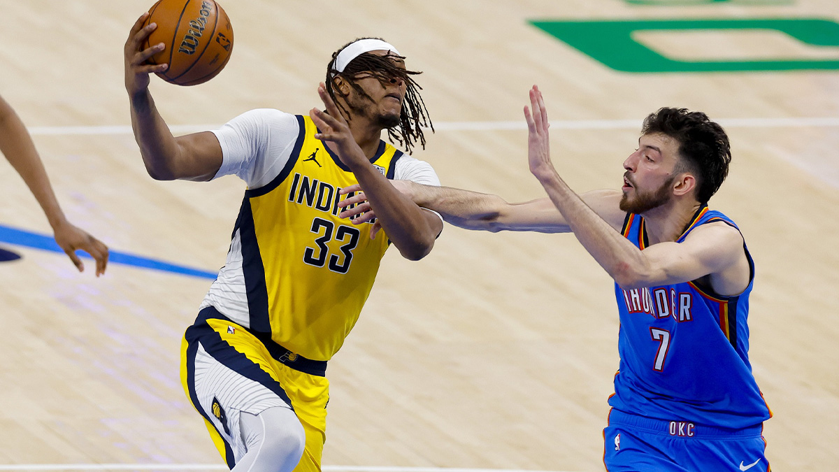 Pacers center Myles Turner (33) drives to the basket past Oklahoma City Thunder forward Chet Holmgren (7) during the third quarter of game two of the 2025 NBA Finals at Paycom Center