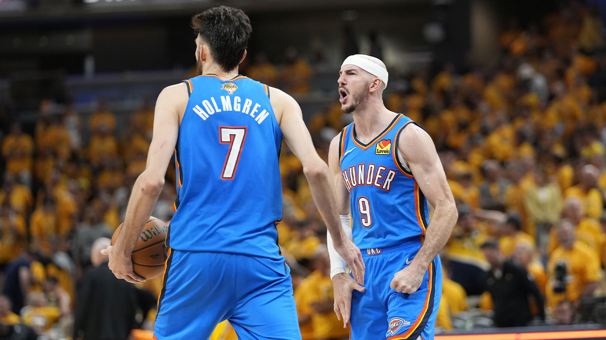 Thunder guard Alex Caruso (9) and forward Chet Holmgren (7) react after defeating the Indiana Pacers in game four of the 2025 NBA Finals at Gainbridge Fieldhouse with Thunder All-Star Jalen Williams in the background