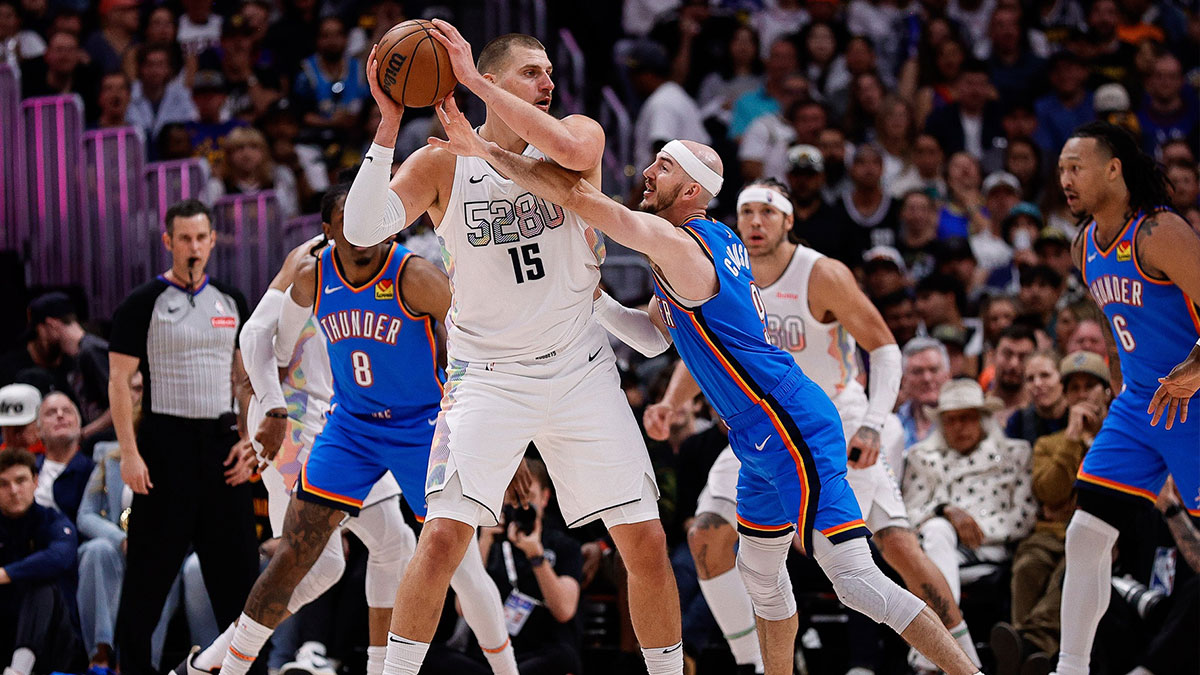 Nuggets center Nikola Jokic (15) controls the ball under pressure form Oklahoma City Thunder guard Alex Caruso (9) in the second quarter during game six of the second round for the 2025 NBA Playoffs at Ball Arena