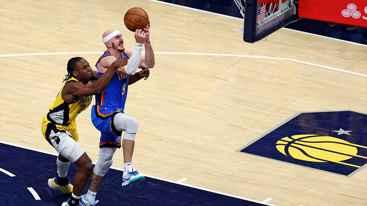 Thunder guard Alex Caruso (9) during the fourth quarter in game three of the 2025 NBA Finals at Gainbridge Fieldhouse with the Lakers logo in the background