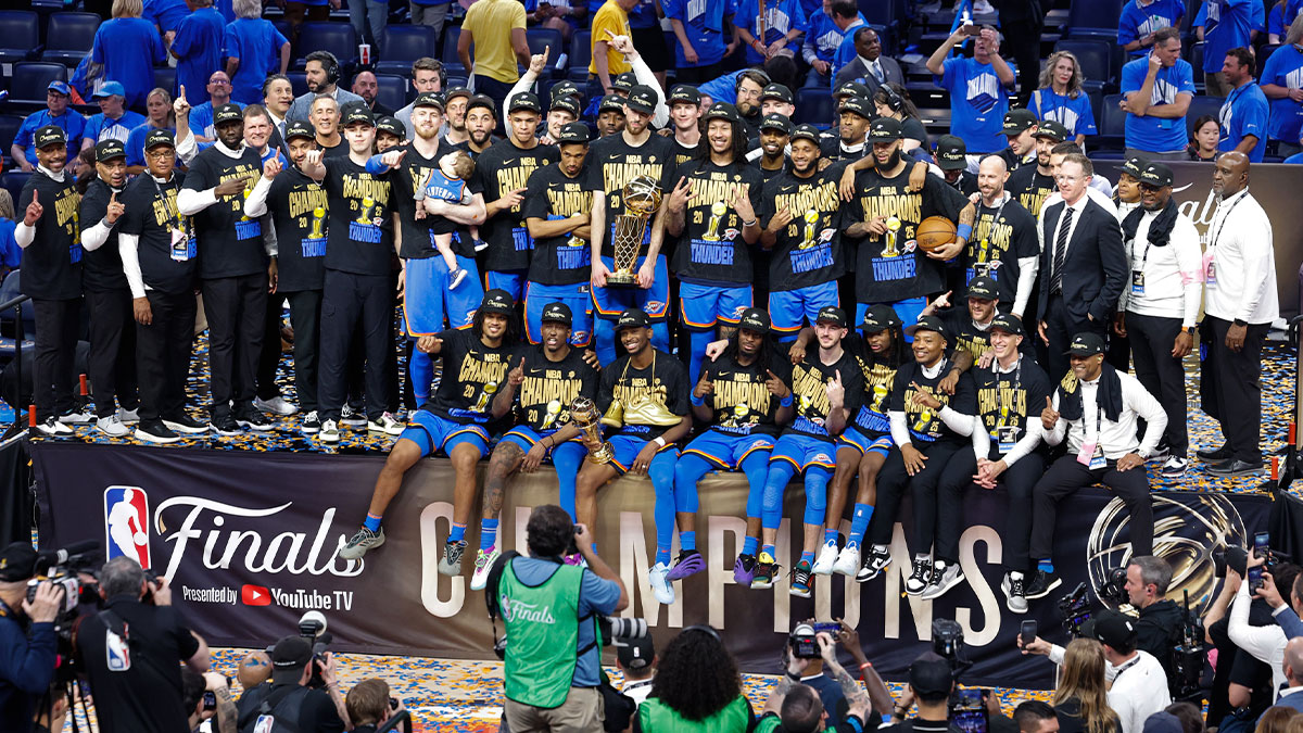 The Oklahoma City Thunder pose for a team photo with the Larry O'Brien Championship Trophy as they celebrate after winning game seven of the 2025 NBA Finals against the Indiana Pacers at Paycom Center.