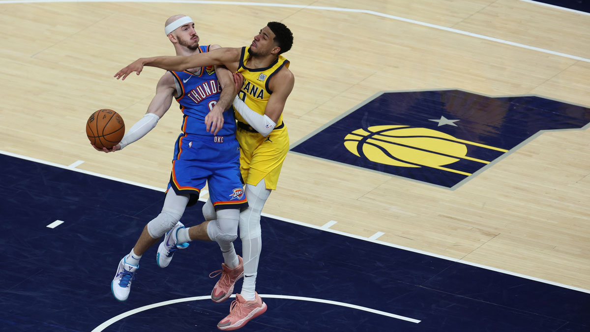 Thunder guard Alex Caruso (9) drives to the hoop past Indiana Pacers guard Tyrese Haliburton (0) during the fourth quarter of game four of the 2025 NBA Finals at Gainbridge Fieldhouse
