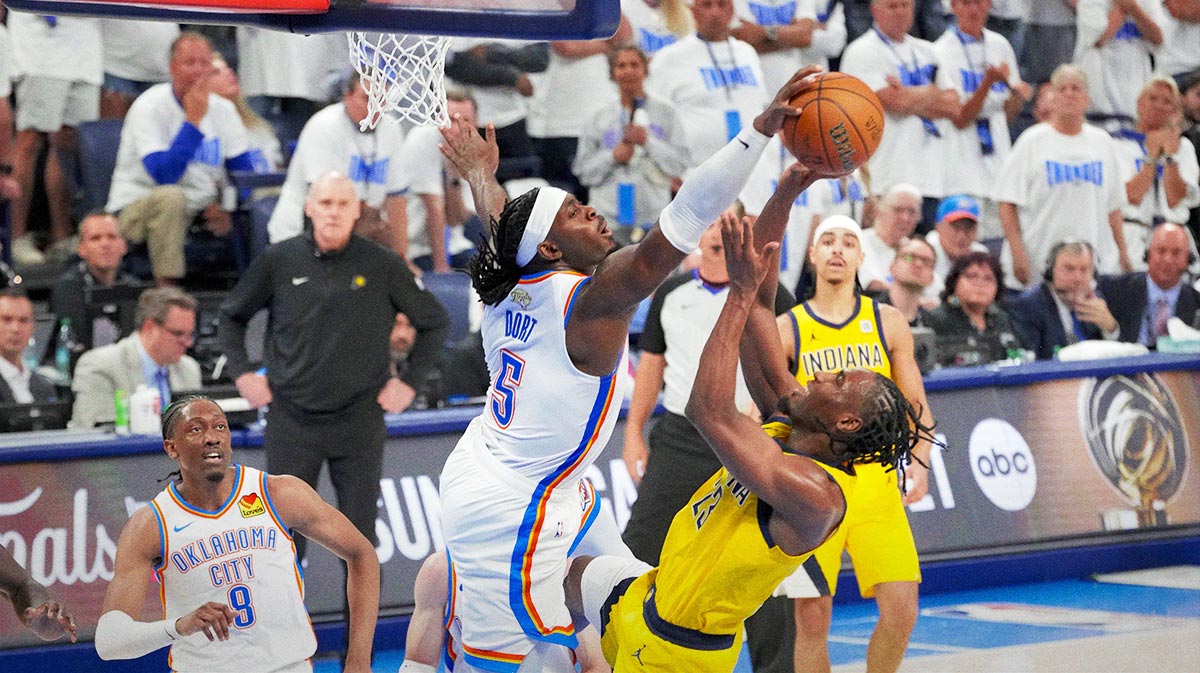 Oklahoma City Thunder guard Luguentz Dort (5) blocks a shot by Indiana Pacers forward Aaron Nesmith (23) during the fourth quarter during game one of the 2025 NBA Finals at Paycom Center.