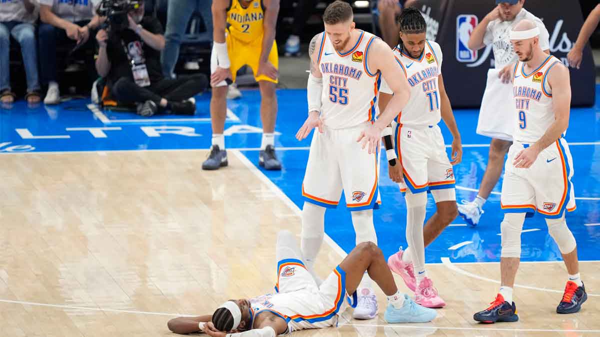 Thunder center Isaiah Hartenstein (55) and guard Shai Gilgeous-Alexander (bottom) react after a play against the Indiana Pacers during the third quarter in game one of the 2025 NBA Finals at Paycom Center