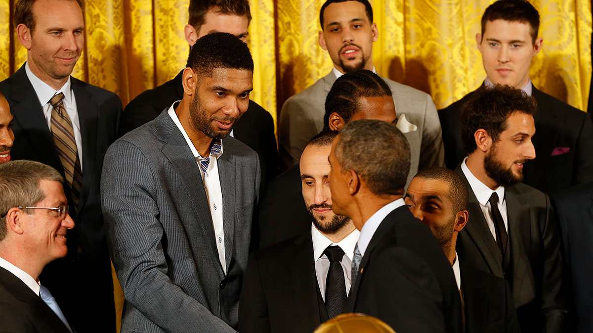 San Antonio Spurs forward Tim Duncan (left) shakes hands with President Barack Obama (right) during a ceremony honoring the NBA Champion Spurs in the East Room at The White House.