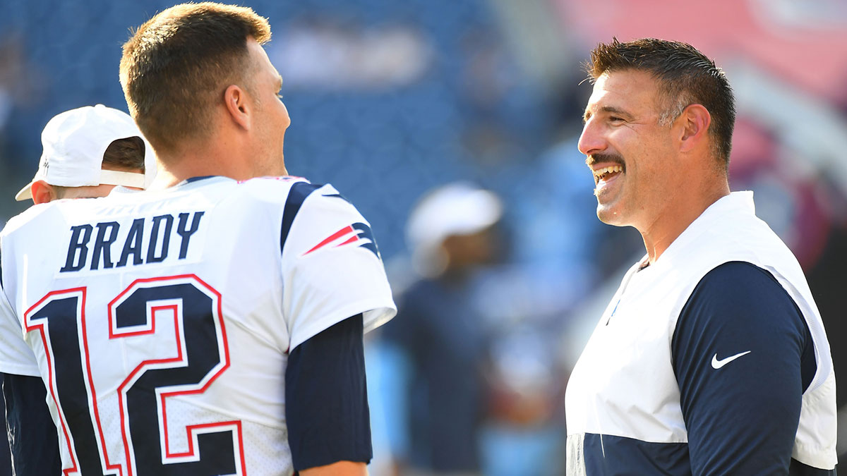 Tennessee Titans head coach Mike Vrabel talks with New England Patriots quarterback Tom Brady (12) before the preseason game at Nissan Stadium.