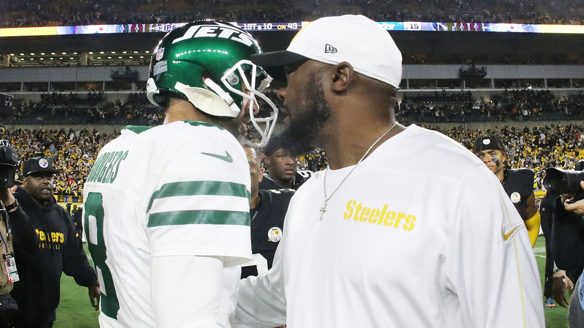 New York Jets quarterback Aaron Rodgers (8) and Pittsburgh Steelers head coach Mike Tomlin (right) greet each other after their game at Acrisure Stadium.
