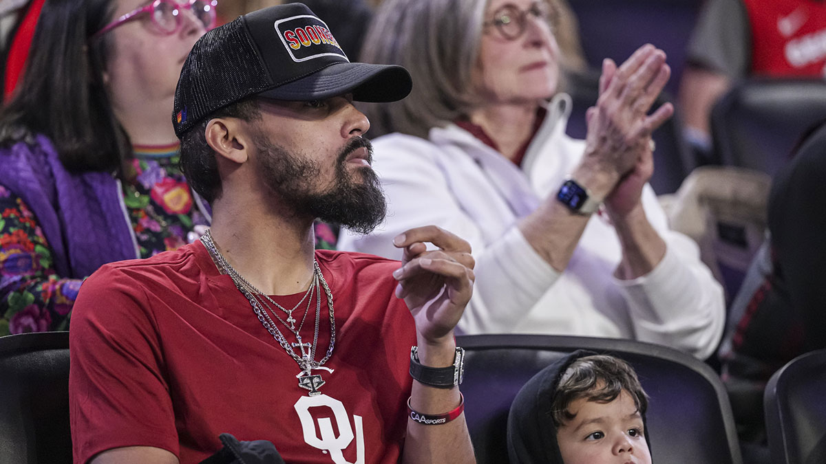Atlanta Hawks player Trae Young with his son Tydus watch the game between the Georgia Bulldogs and the Oklahoma Sooners at Stegeman Coliseum.