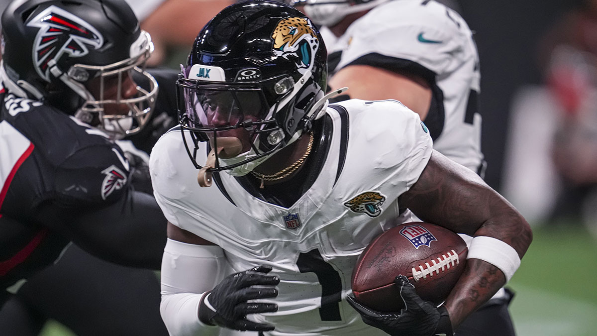 Aug 23, 2024; Atlanta, Georgia, USA; Jacksonville Jaguars running back Travis Etienne Jr. (1) runs against the Atlanta Falcons during the first half at Mercedes-Benz Stadium.