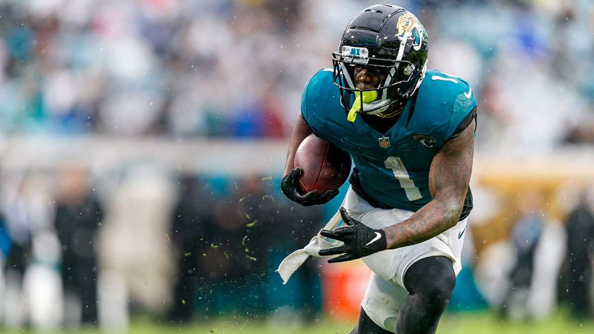 Dec 29, 2024; Jacksonville, Florida, USA; Jacksonville Jaguars running back Travis Etienne Jr. (1) runs the ball against the Tennessee Titans during the second quarter at EverBank Stadium. Mandatory Credit: Morgan Tencza-Imagn Images