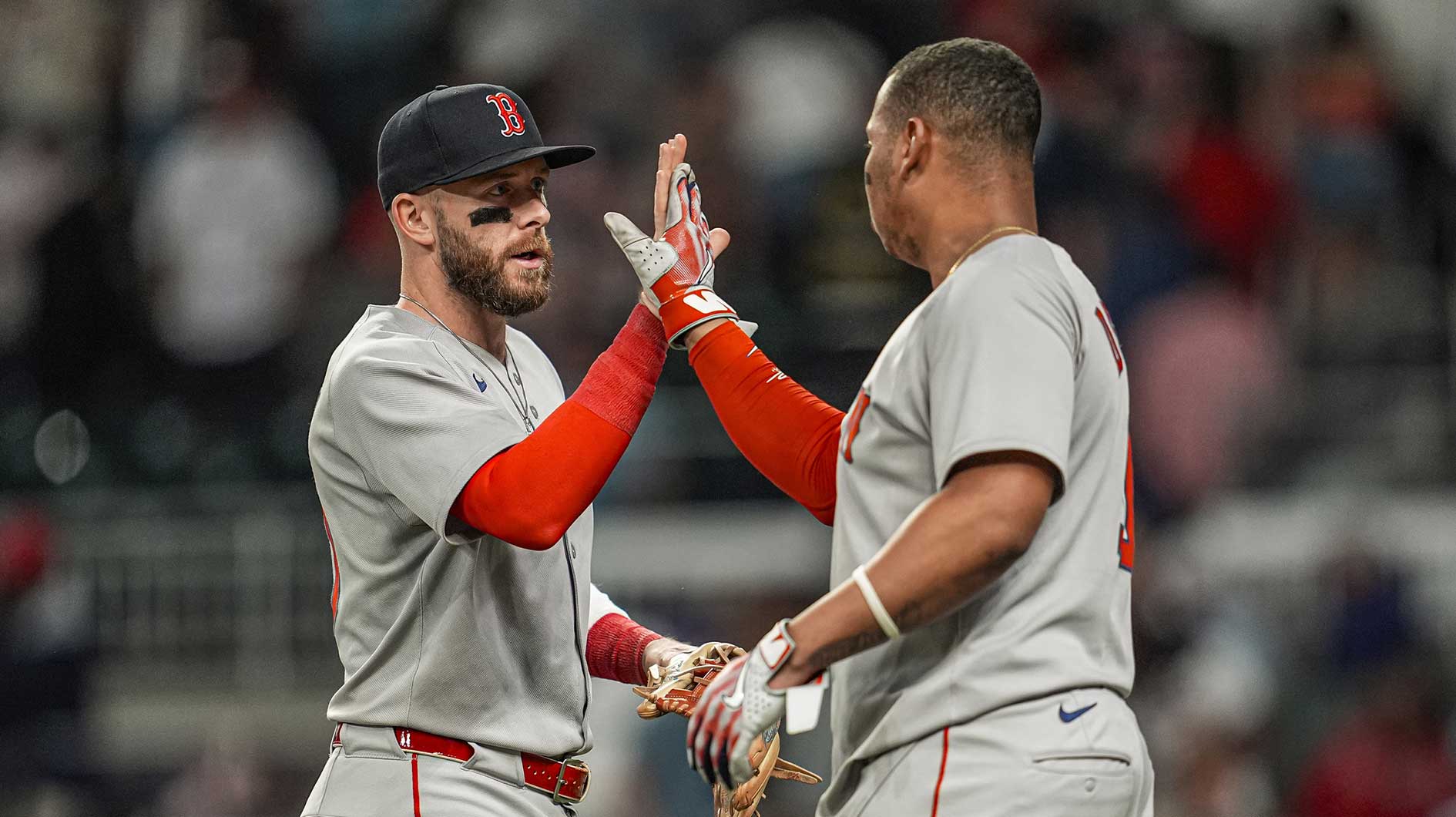Boston Red Sox shortstop Trevor Story (10) and designated hitter Rafael Devers (11) react after the Red Sox defeated the Atlanta Braves.