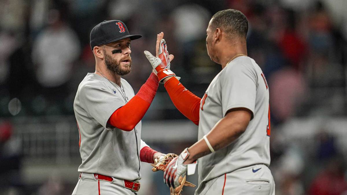 Boston Red Sox shortstop Trevor Story (10) and designated hitter Rafael Devers (11) react after the Red Sox defeated the Atlanta Braves.