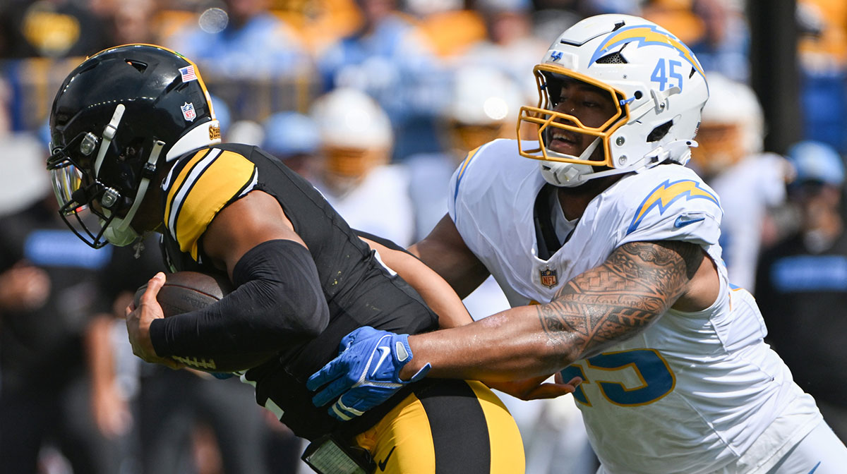 Pittsburgh Steelers quarterback Justin Fields (2) is tackled by Los Angeles Chargers linebacker Tuli Tuipulotu (45) during the first quarter at Acrisure Stadium.