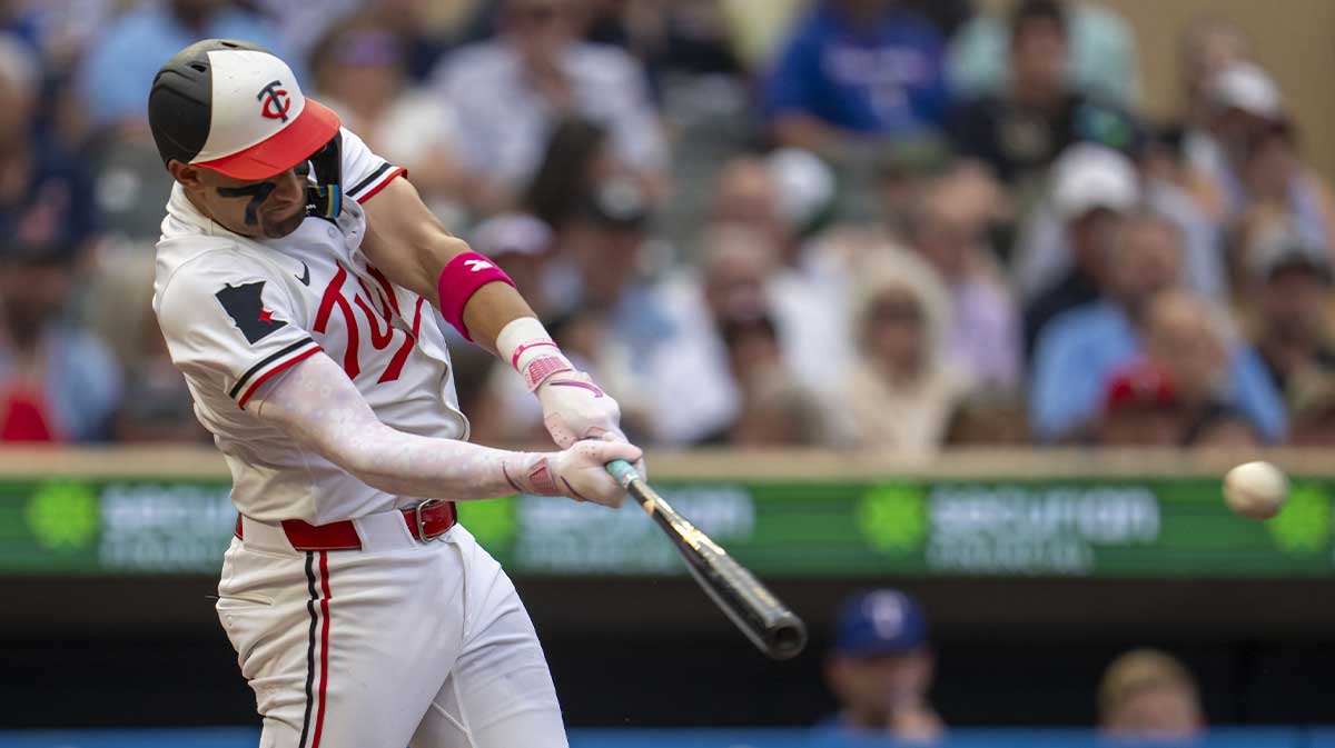 Minnesota Twins third baseman Royce Lewis (23) hits a RBI single against the Texas Rangers in the fourth inning at Target Field.