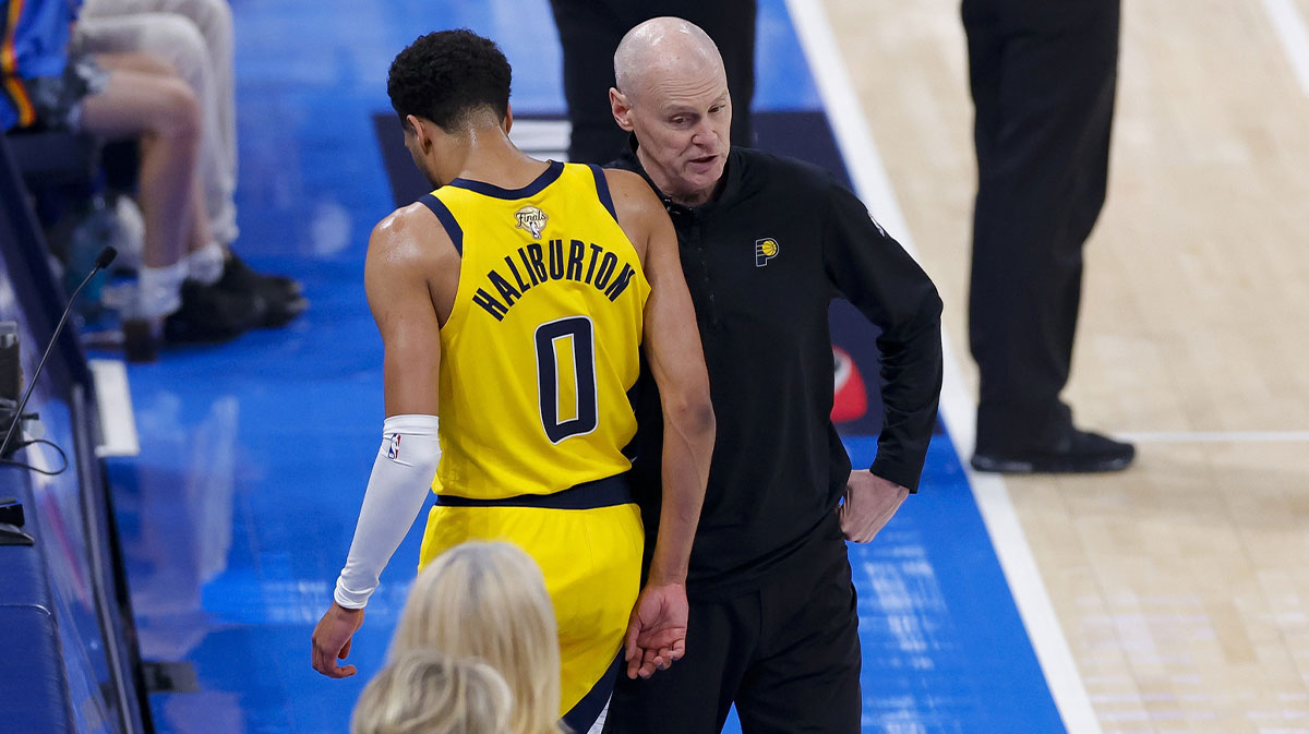 Indiana Pacers guard Tyrese Haliburton (0) comes off the floor past head coach Rick Carlisle in the first quarter against the Oklahoma City Thunder during game five of the 2025 NBA Finals at Paycom Center.