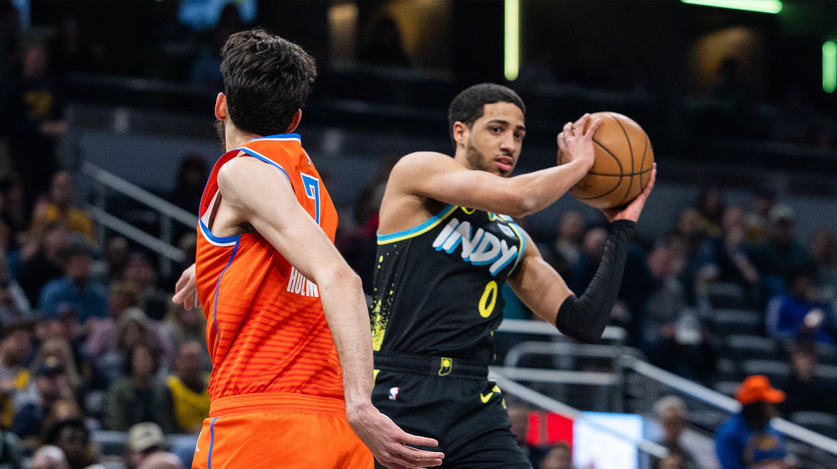 Indiana Pacers guard Tyrese Haliburton (0) passes the ball while Oklahoma City Thunder forward Chet Holmgren (7) defends in the first half at Gainbridge Fieldhouse.