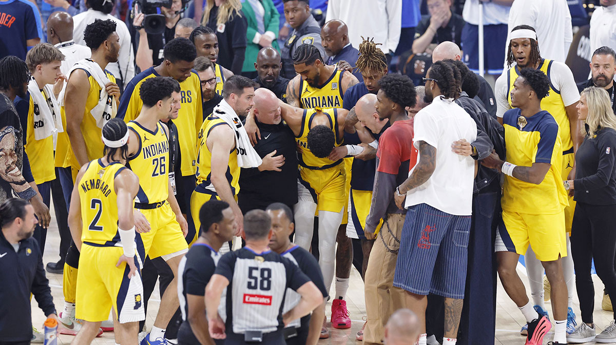 Indiana Pacers guard Tyrese Haliburton (0) is assisted after an apparent injury following a play against the Oklahoma City Thunder during the first half of game seven of the 2025 NBA Finals at Paycom Center.