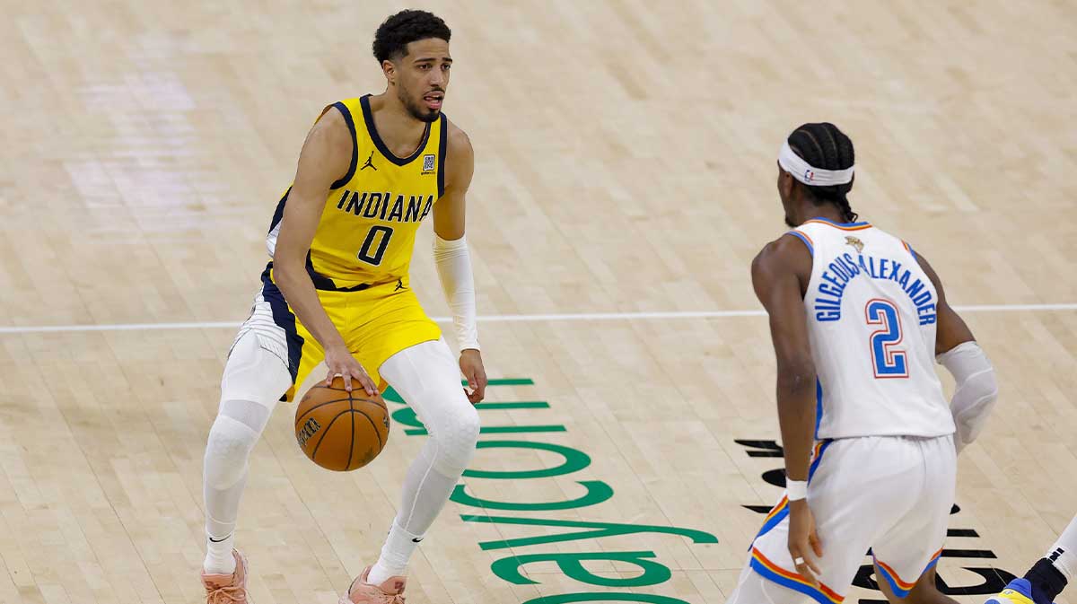Indiana Pacers guard Tyrese Haliburton (0) brings the ball up court against Oklahoma City Thunder guard Shai Gilgeous-Alexander (2) during the third quarter in game five of the 2025 NBA Finals at Paycom Center.