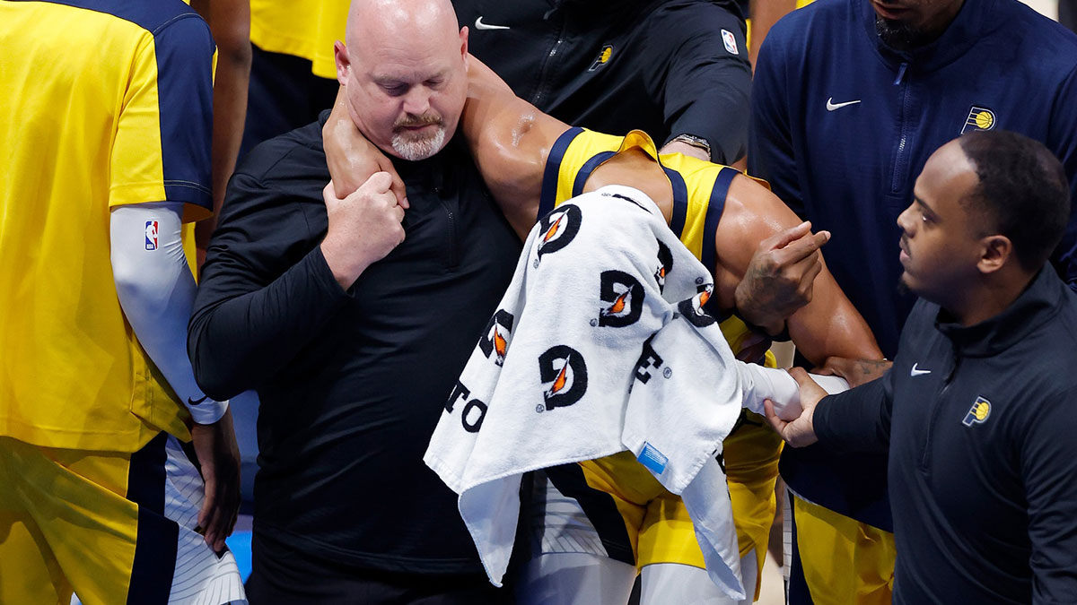 Indiana Pacers guard Tyrese Haliburton (0) is assisted after an apparent injury following a play against the Oklahoma City Thunder during the first half of game seven of the 2025 NBA Finals at Paycom Center.