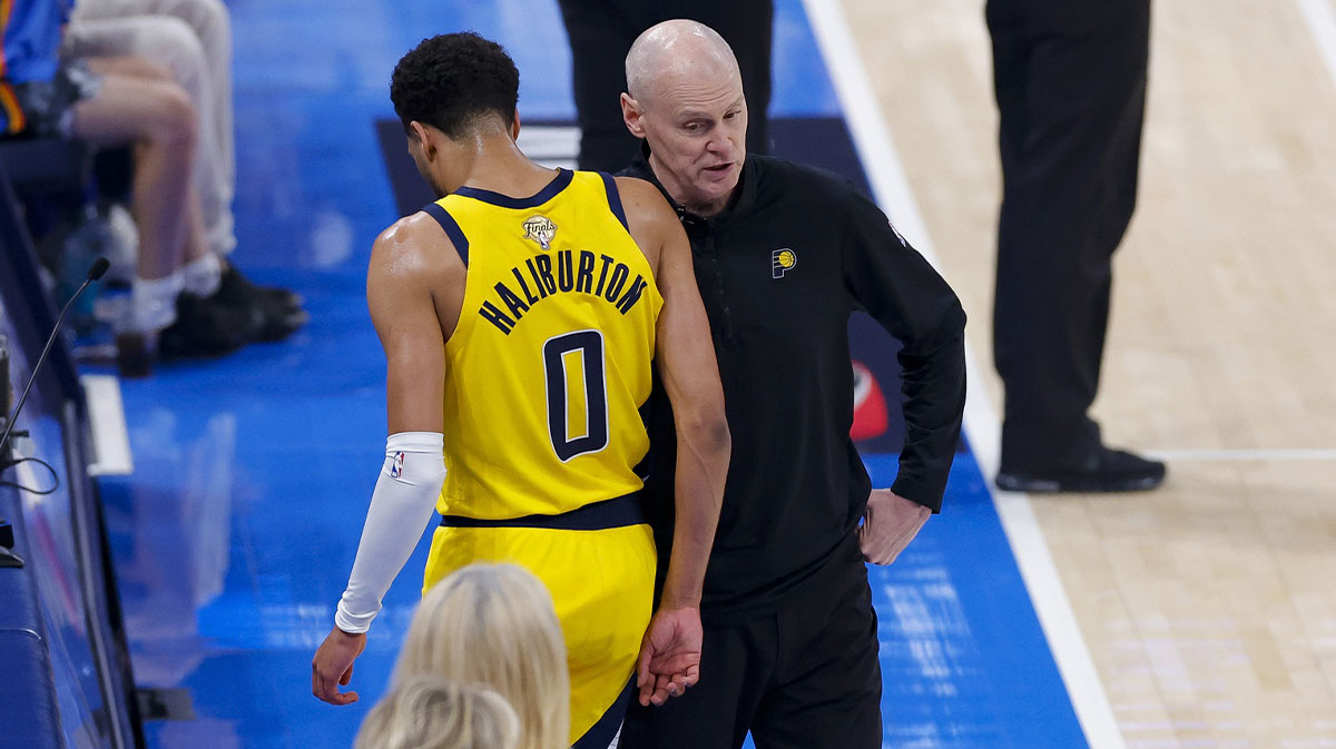 Indiana Pacers guard Tyrese Haliburton (0) comes off the floor past head coach Rick Carlisle in the first quarter against the Oklahoma City Thunder during game five of the 2025 NBA Finals at Paycom Center.