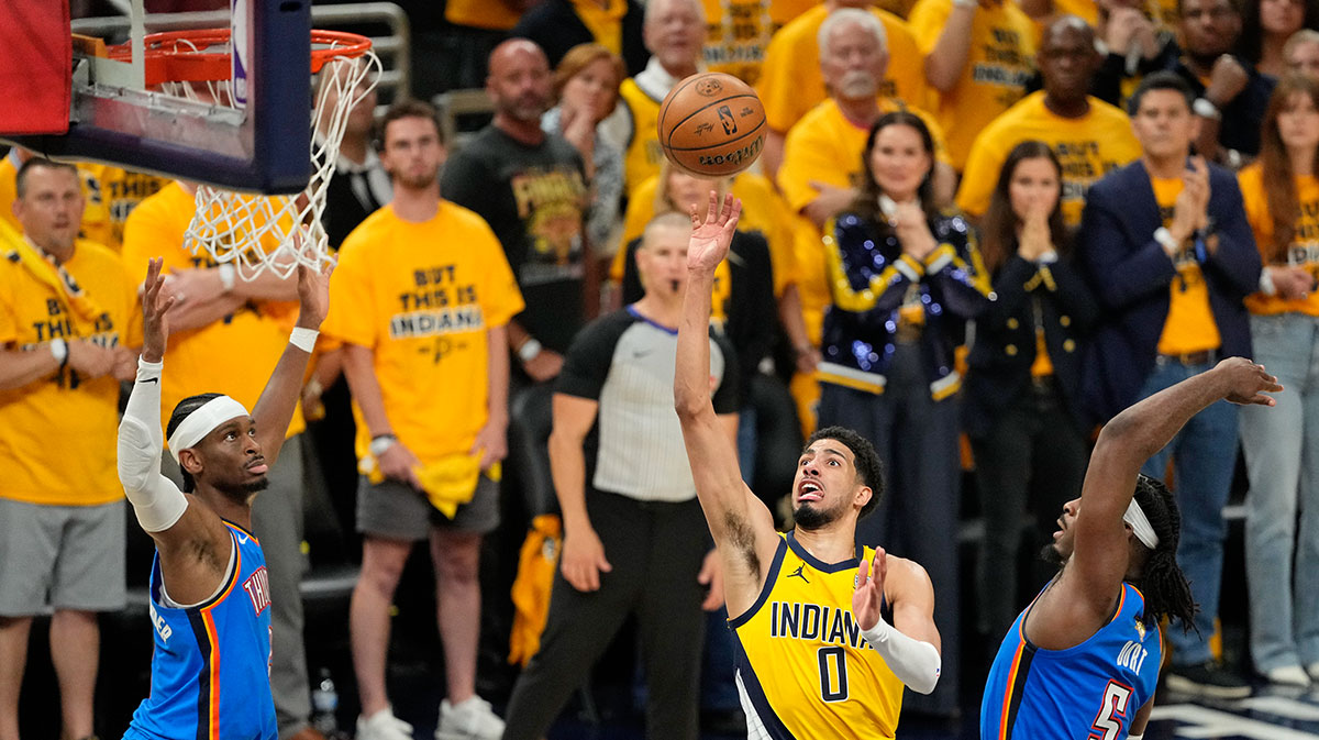 Indiana Pacers guard Tyrese Haliburton (0) shoots the ball against Oklahoma City Thunder guard Luguentz Dort (5) during the second half during game three of the 2025 NBA Finals at Gainbridge Fieldhouse.