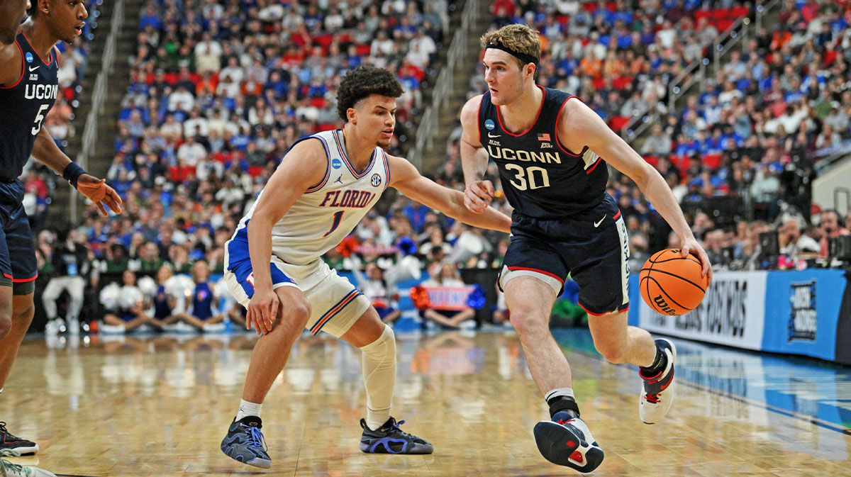 Connecticut Huskies forward Liam McNeeley (30) drives to the basket during the second half against Florida Gators guard Walter Clayton Jr. (1) in the second round of the NCAA Tournament at Lenovo Center. Barnes Bitadze