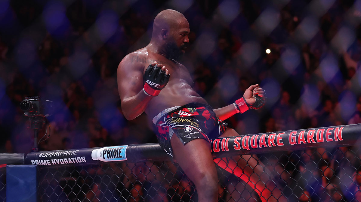 Jon Jones (red gloves) celebrates defeating Stipe Miocoic (blue gloves) in the heavyweight bout during UFC 309 at Madison Square Garden.