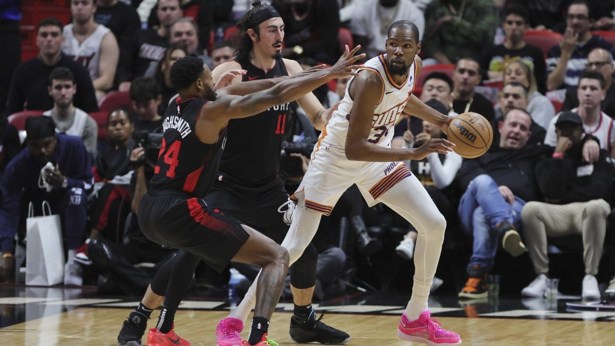 Phoenix Suns forward Kevin Durant (35) protects the basketball from Miami Heat forward Haywood Highsmith (24) and guard Jaime Jaquez Jr. (11) during the third quarter at Kaseya Center.