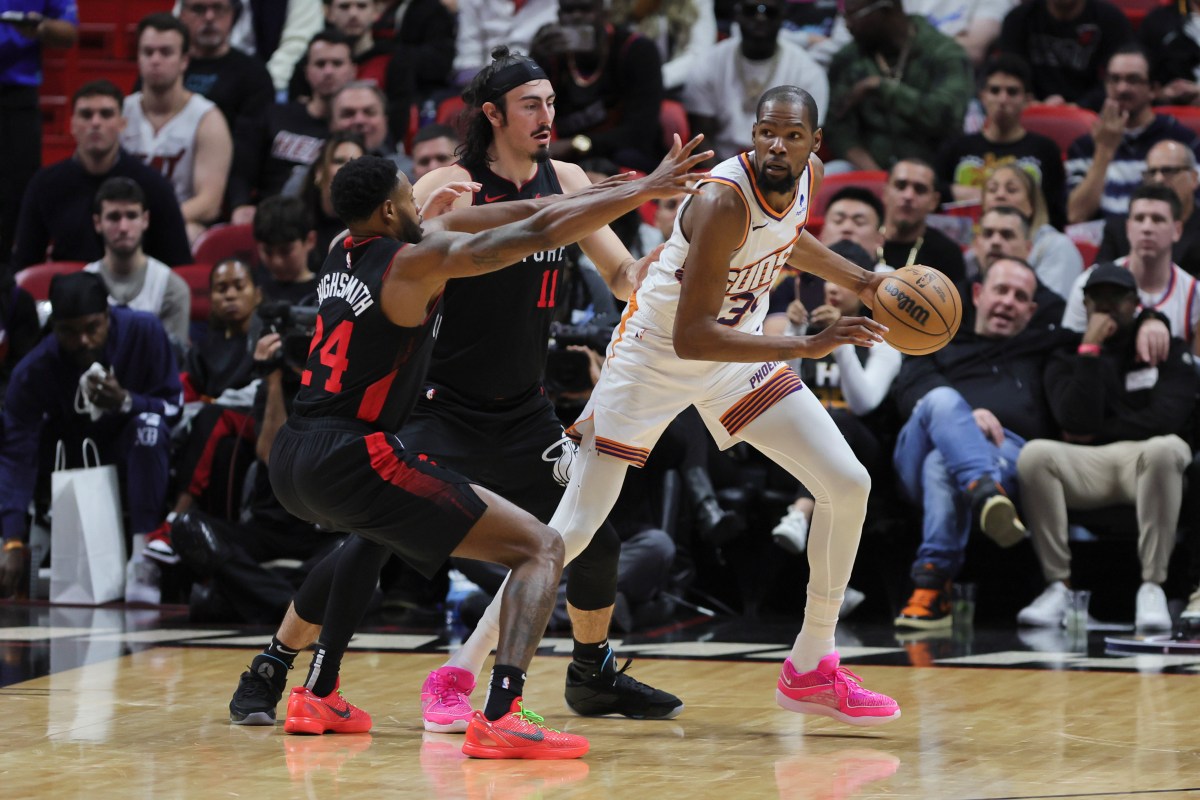 Phoenix Suns forward Kevin Durant (35) protects the basketball from Miami Heat forward Haywood Highsmith (24) and guard Jaime Jaquez Jr. (11) during the third quarter at Kaseya Center.