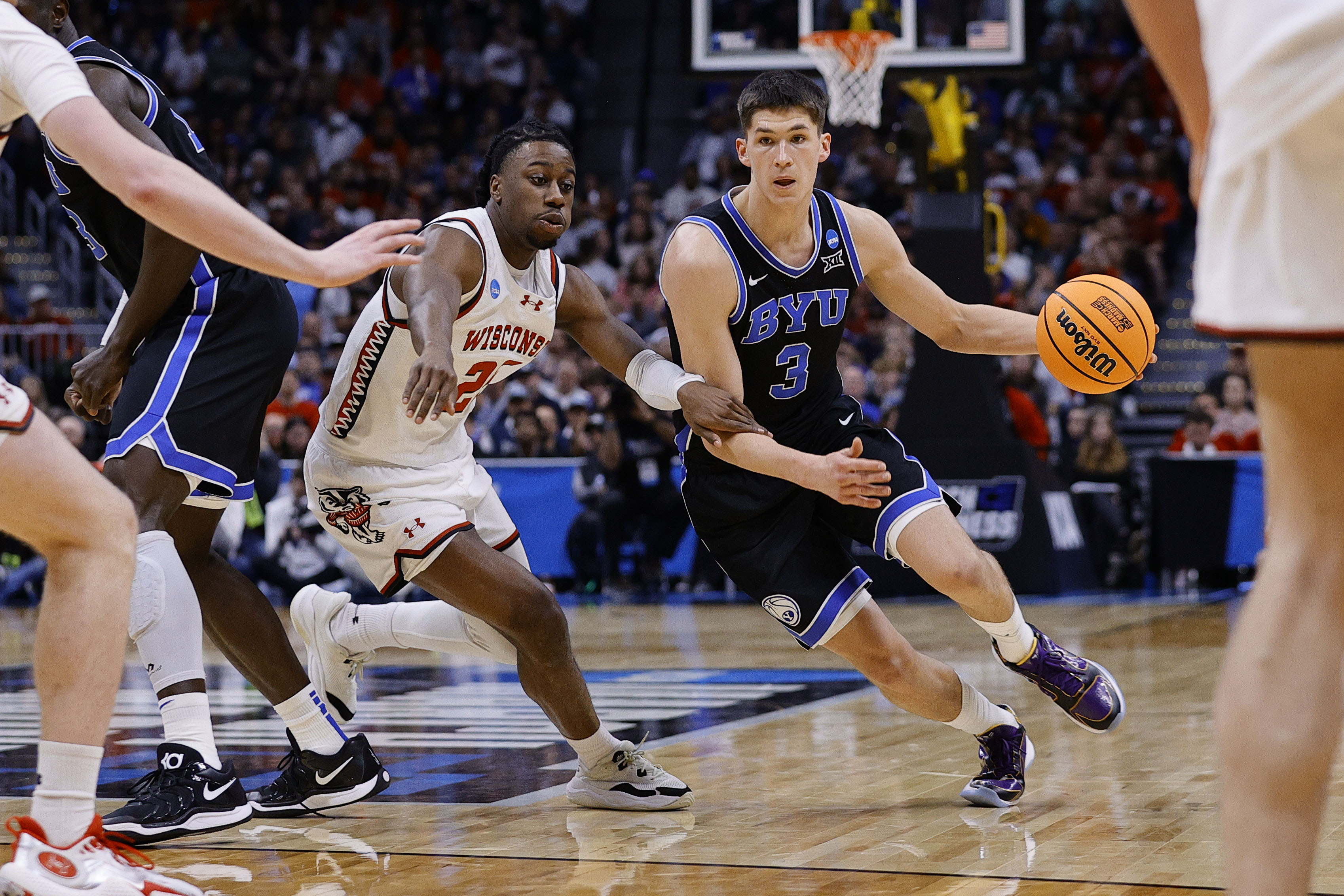 Brigham Young Cougars guard Egor Demin (3) dribbles the ball past Wisconsin Badgers guard John Blackwell (25) during the second half in the second round of the NCAA Tournament at Ball Arena.
