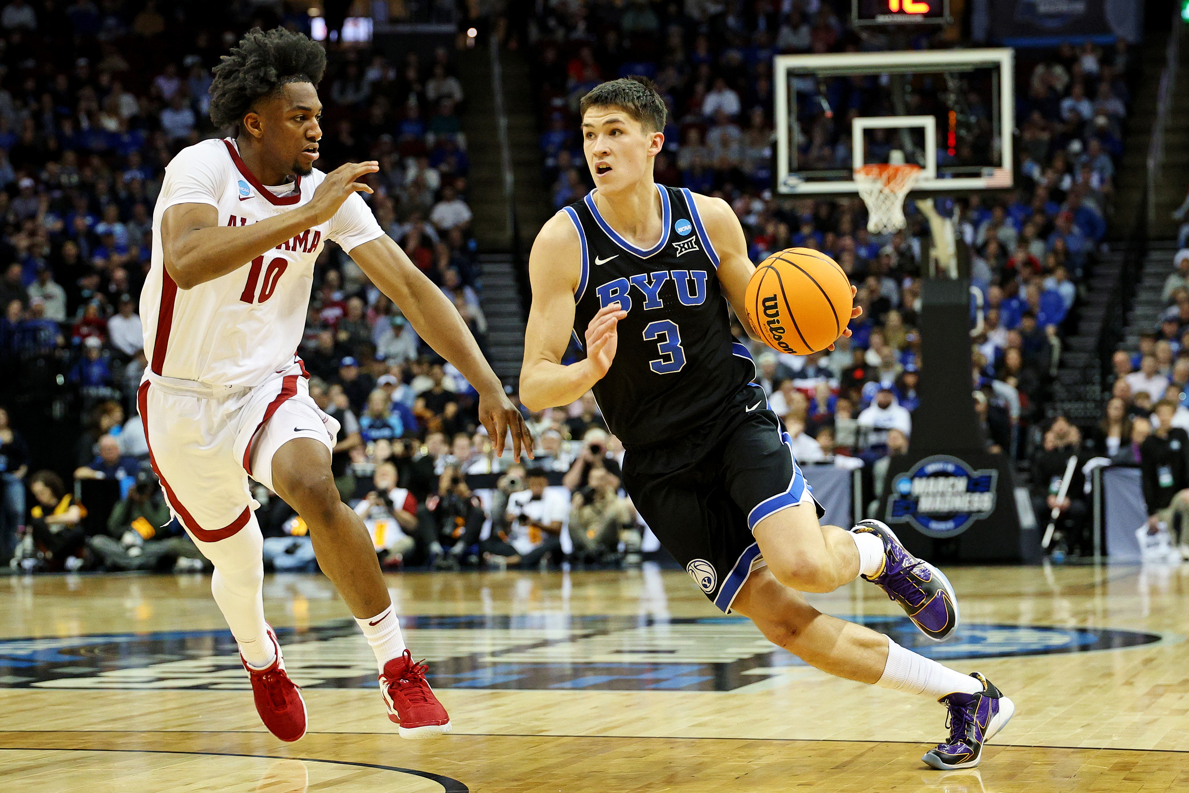 Brigham Young Cougars guard Egor Demin (3) drives to the basket against Alabama Crimson Tide forward Mouhamed Dioubate (10) during the first half during an East Regional semifinal of the 2025 NCAA tournament at Prudential Center.