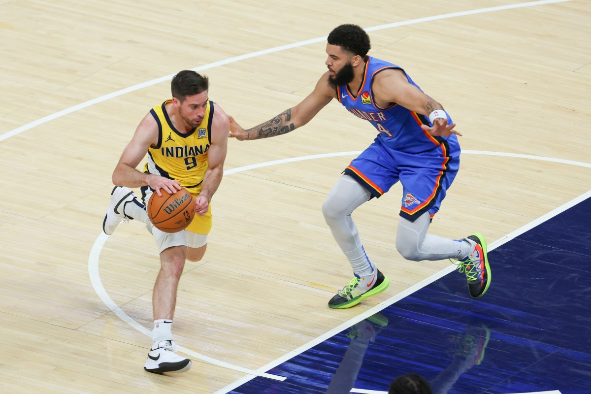 Indiana Pacers guard T.J. McConnell (9) drives to the basket defended by Oklahoma City Thunder forward Kenrich Williams (34) in the second quarter during game six of the 2025 NBA Finals at Gainbridge Fieldhouse.