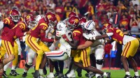 Arizona Wildcats running back Jonah Coleman (3) is stopped short of the goal line by Southern California Trojans safety Calen Bullock (7) and linebacker Eric Gentry (18) during the second half at Los Angeles Memorial Coliseum. Mandatory Credit: Gary A. Vasquez-Imagn Images