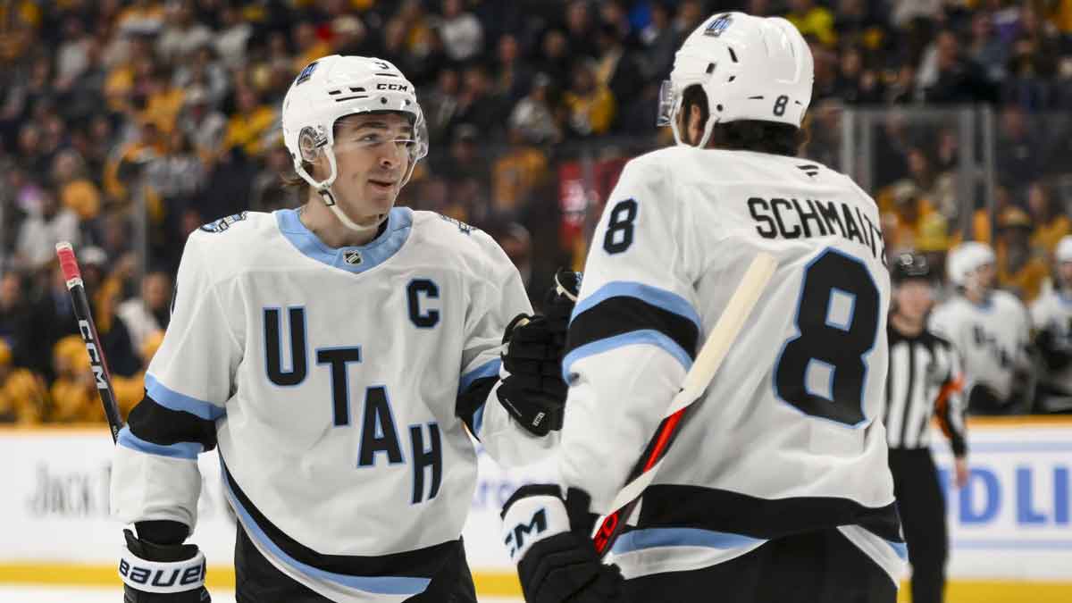 Utah Hockey Club center Nick Schmaltz (8) celebrates a goal with center Clayton Keller (9) against the Nashville Predators during the second period at Bridgestone Arena.