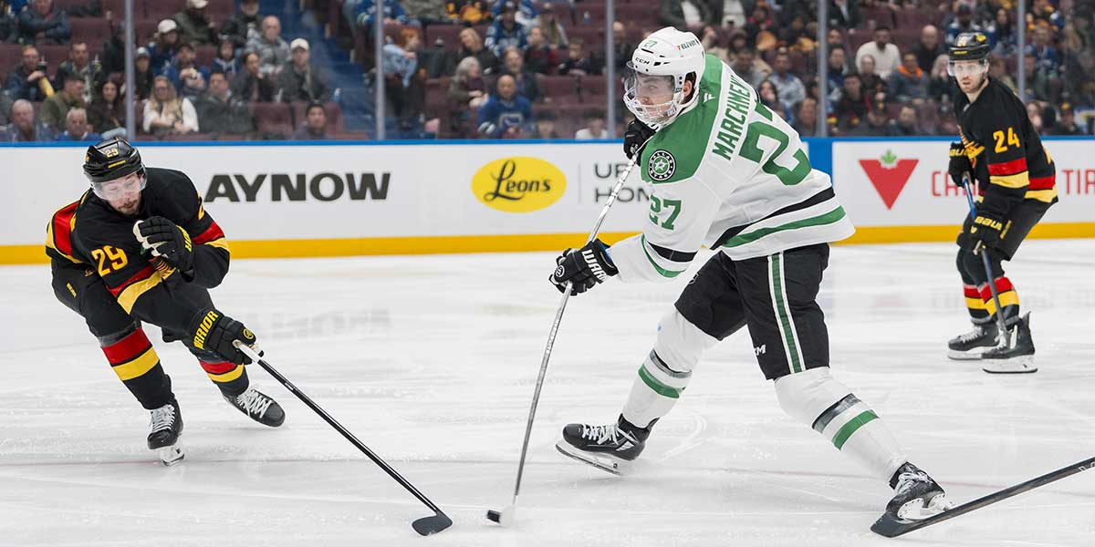 Vancouver Canucks defenseman Marcus Pettersson (29) stick checks Dallas Stars forward Mason Marchment (27) in the third period at Rogers Arena.