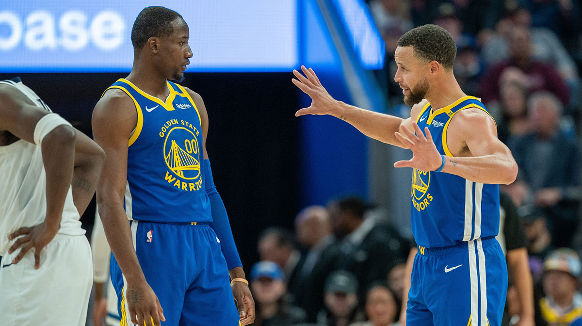 Warriors guard Stephen Curry (30) speaks with forward Jonathan Kuminga (00) during a time out against the Minnesota Timberwolves during the fourth quarter at Chase Center