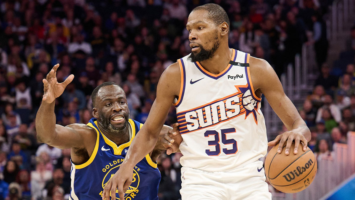 Phoenix Suns forward Kevin Durant (35) controls the ball against Golden State Warriors forward Draymond Green (23) during the third quarter at Chase Center.