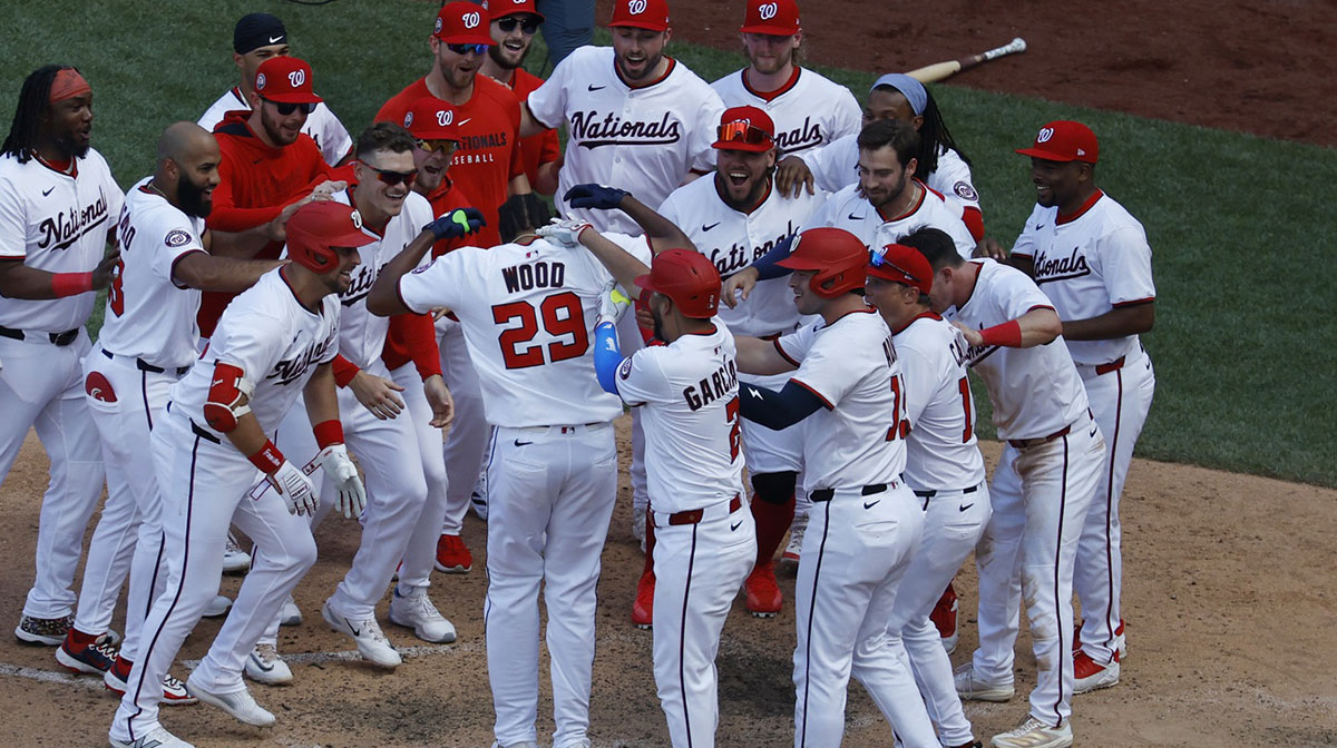 Washington Nationals outfielder James Wood (29) celebrates at home plate with teammates after hitting a walk off two run home run against the Colorado Rockies during the eleventh inning at Nationals Park. abrams