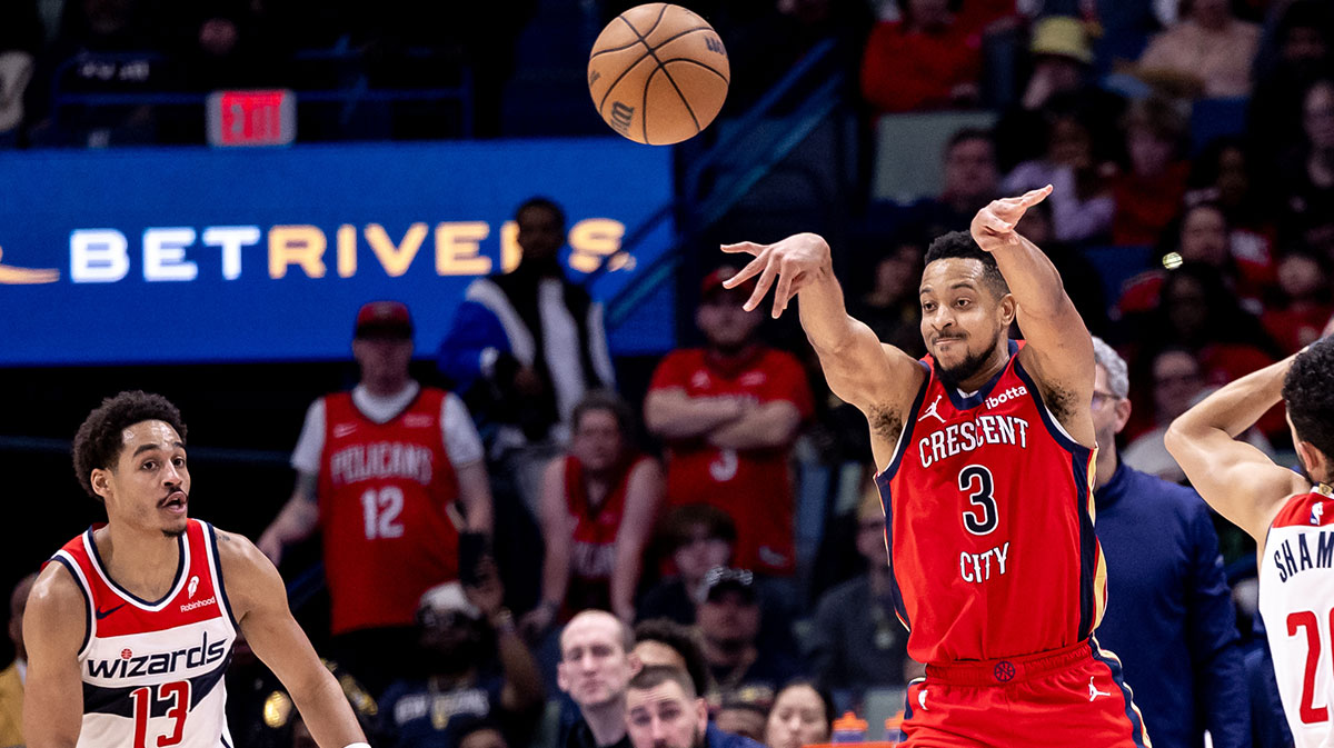 New Orleans Pelicans guard CJ McCollum (3) passes the ball against Washington Wizards guard Jordan Poole (13) during the second half at Smoothie King Center.