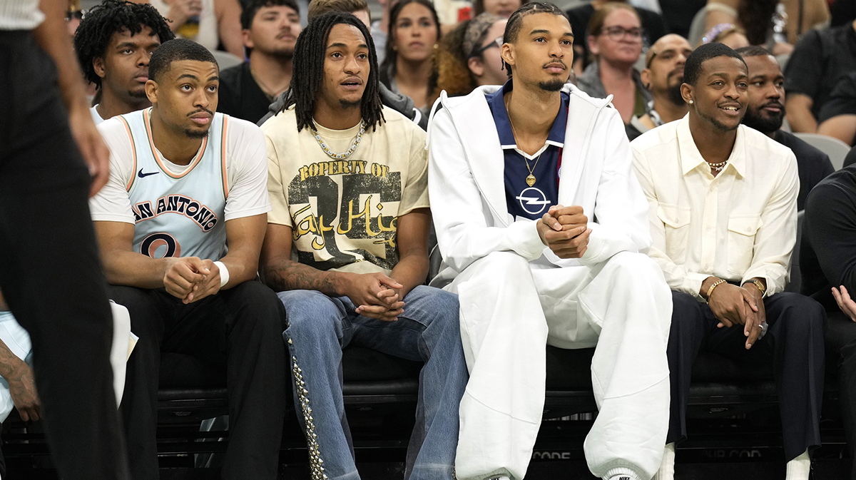 San Antonio Spurs (from left to right) forward Keldon Johnson (0), guard Devin Vassell (24), center Victor Wembanyama (1) and guard De'Aron Fox (4) watch the first half of a game against the Toronto Raptors at Frost Bank Center.