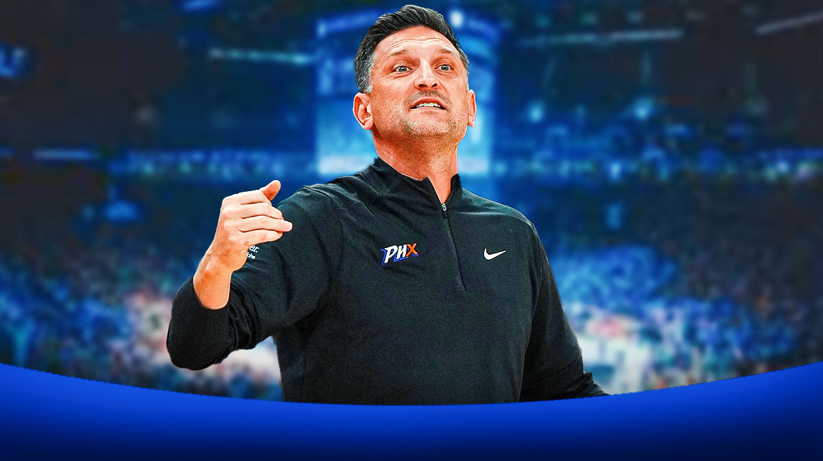 Phoenix Mercury head coach Nate Tibbetts looking happy, with a background of the New York Liberty's home arena.