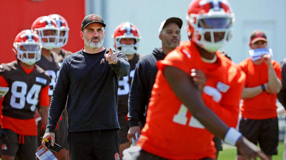 Cleveland Browns coach Kevin Stefanski watches quarterback Shedeur Sanders (12) participate in drills during day two of NFL rookie minicamp at the Cleveland Browns training facility May 10, 2025, in Berea, Ohio.