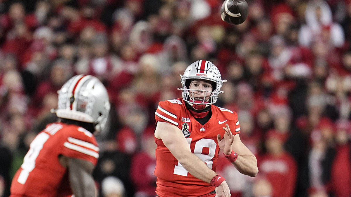 Ohio State Buckeyes quarterback Will Howard (18) throws to wide receiver Jeremiah Smith (4) during the first half of the College Football Playoff first round game against the Tennessee Volunteers at Ohio Stadium in Columbus on Dec. 21, 2024.