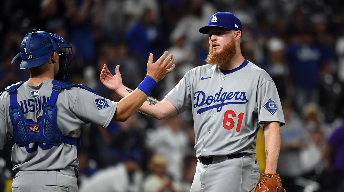 Los Angeles Dodgers pitcher Will Klein (61) celebrates with catcher Dalton Rushing (68) after a win against the Colorado Rockies at Coors Field.